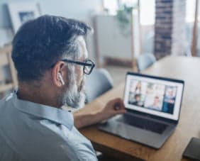 Man watching webinar on laptop